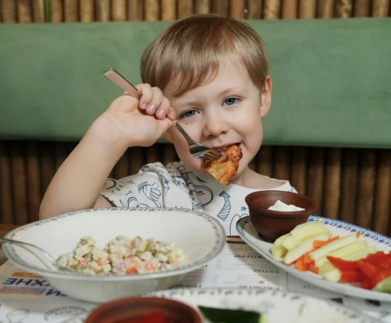 Kid eating food at table